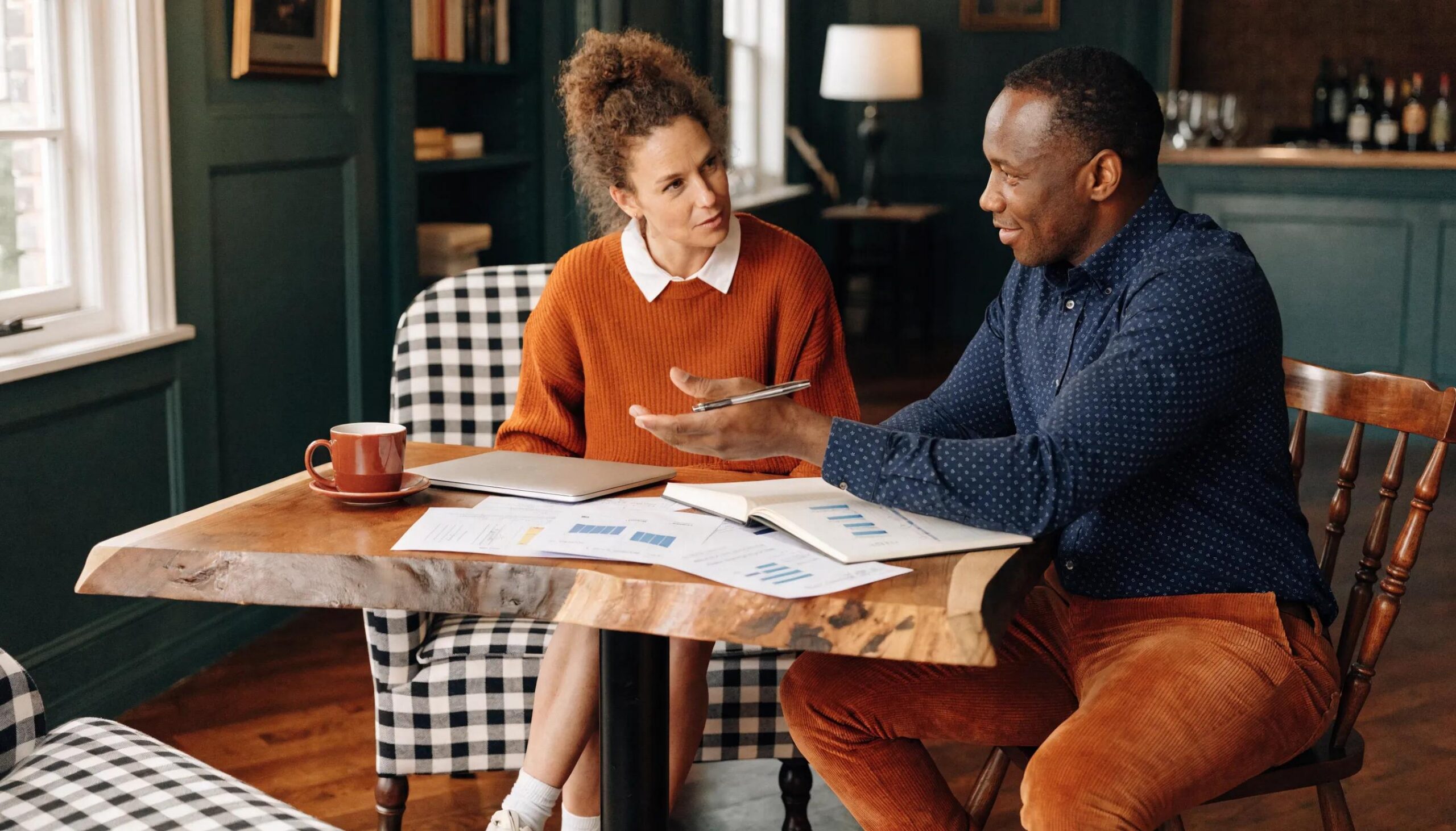 Wealth manager explaining fiduciary duty to a client in an inviting office space