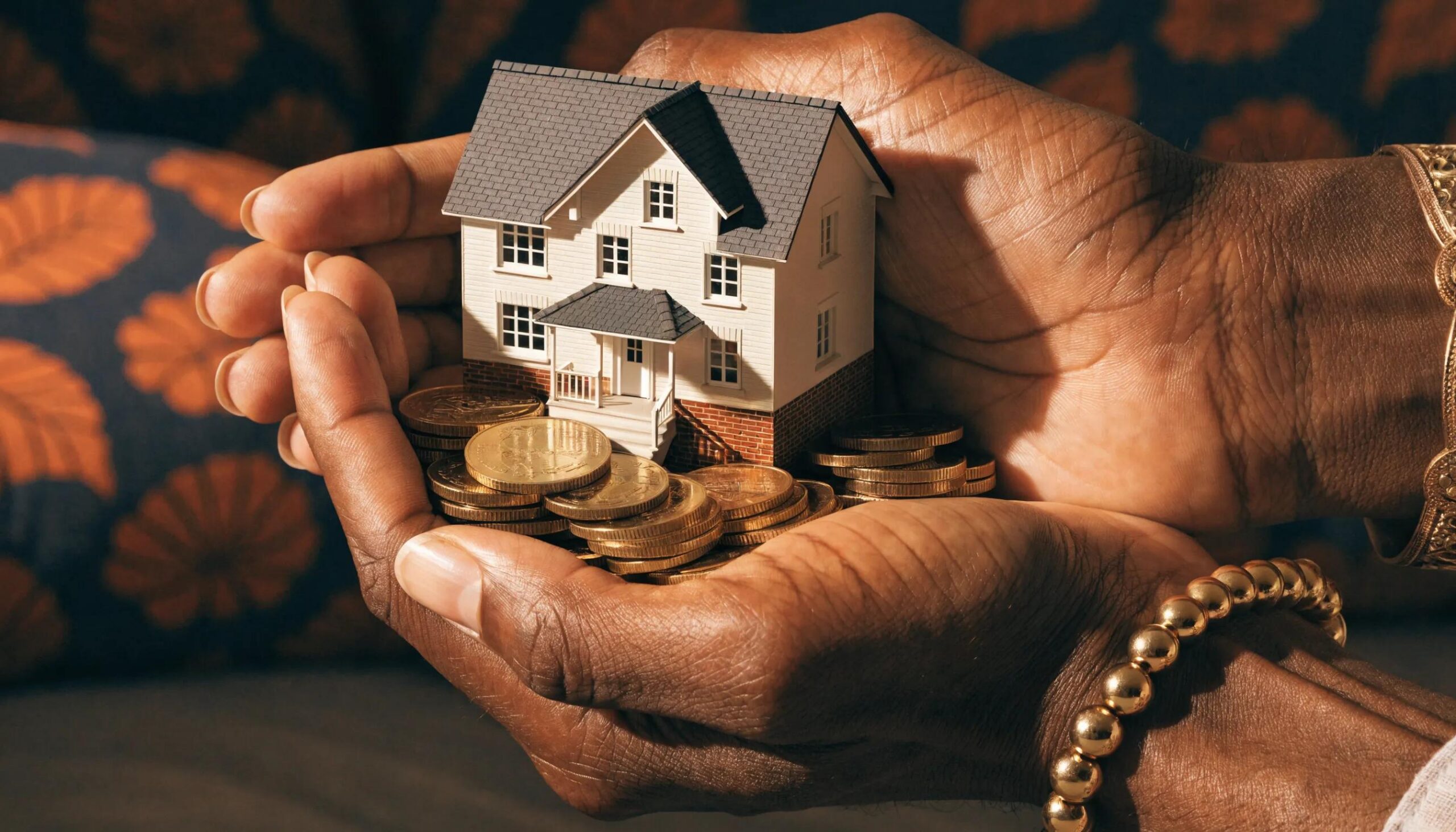 Hands holding a house and coins symbolizing asset protection strategies