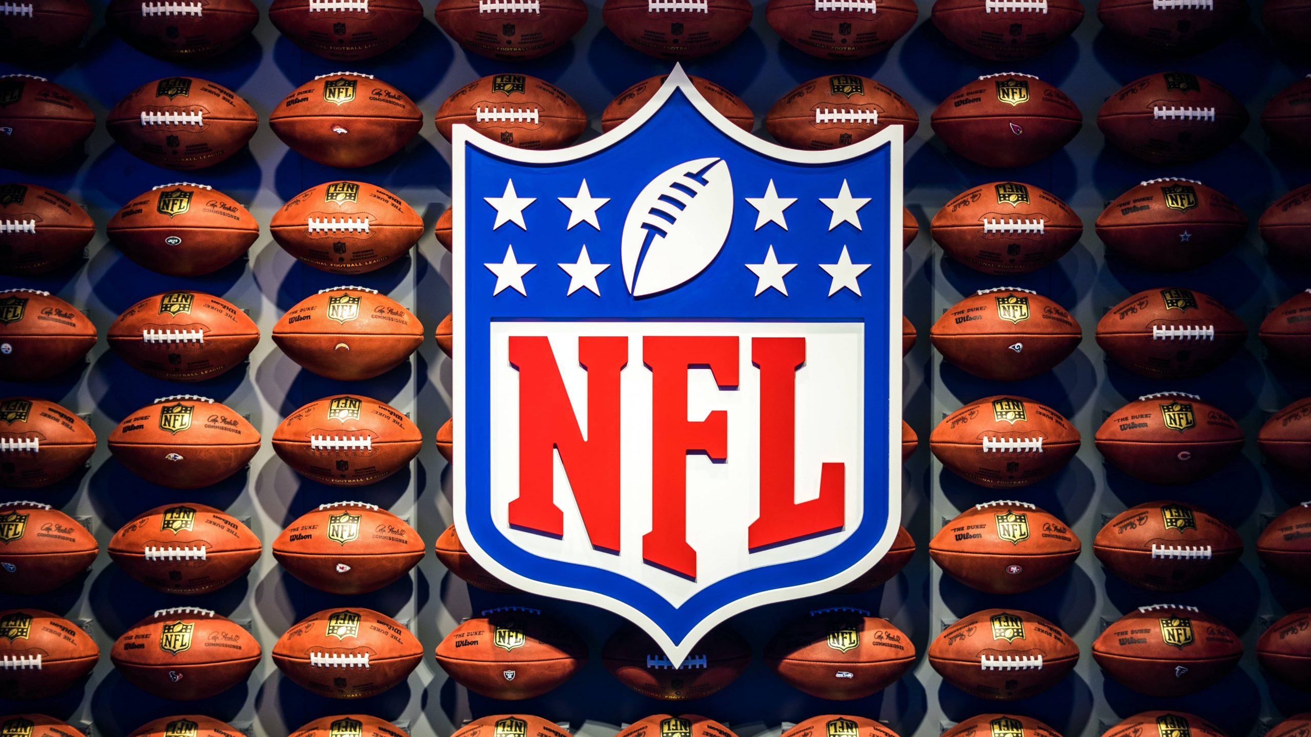 nfl logo on a background of footballs
